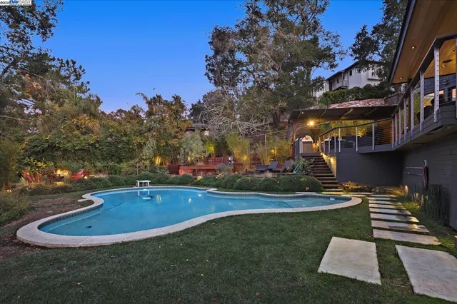 a view of a house with a yard balcony and sitting area
