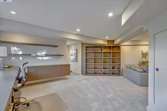 a view of an empty room with a cabinet and mirrors