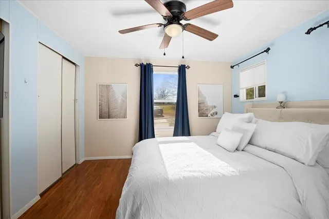 a bedroom with a large bed and a chandelier