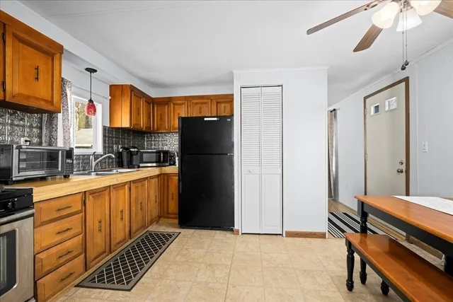 a kitchen with stainless steel appliances a refrigerator and a stove top oven