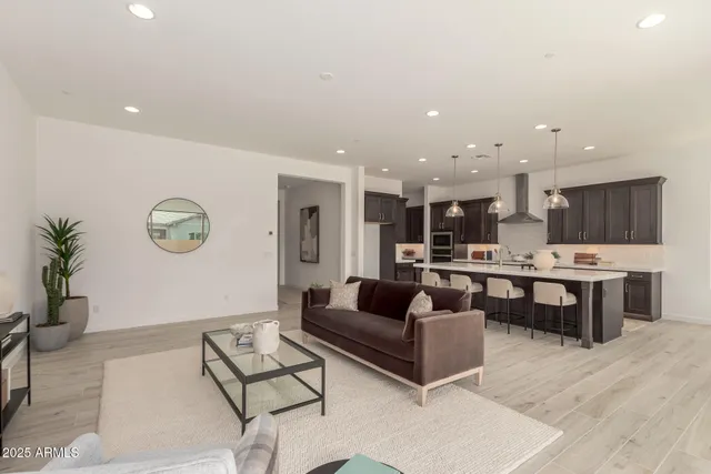 a living room with stainless steel appliances kitchen island granite countertop furniture and a view of kitchen