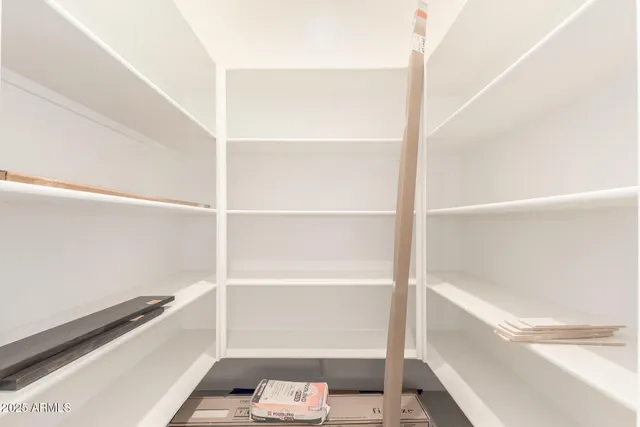 a spacious bedroom with a large bed and a couch