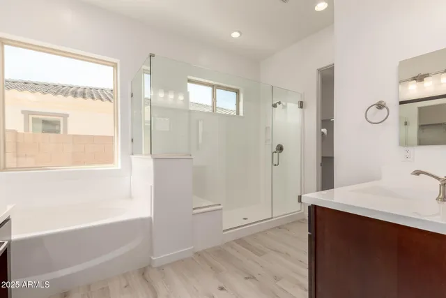 a bathroom with a tub sink and mirror
