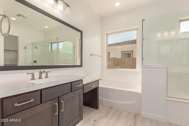 a bathroom with a sink vanity and mirror