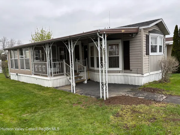 a view of a house with a backyard