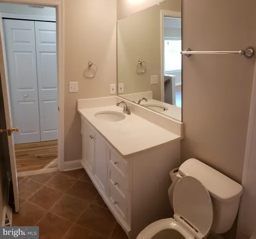 a bathroom with a sink a toilet a mirror and shower