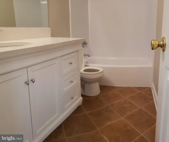 a bathroom with a toilet and a bathtub
