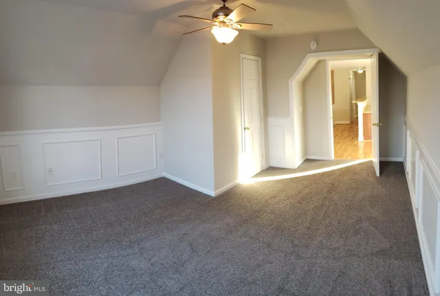 a view of a livingroom with a chandelier fan