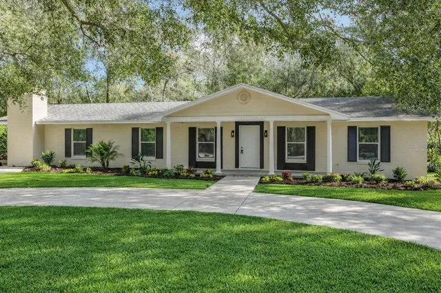a front view of a house with a yard and porch