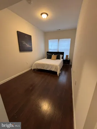 a living room with a bed furniture and a flat screen tv