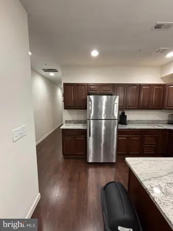 a kitchen with kitchen island wooden cabinets and stainless steel appliances