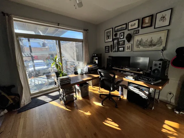 a living room with furniture a flat screen tv and a floor to ceiling window