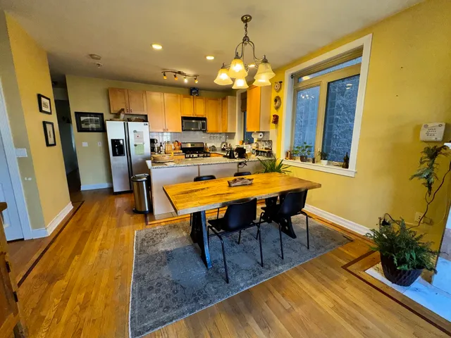 a view of a dining room with furniture and a chandelier