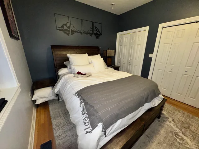 a bed sitting in a bedroom next to a window