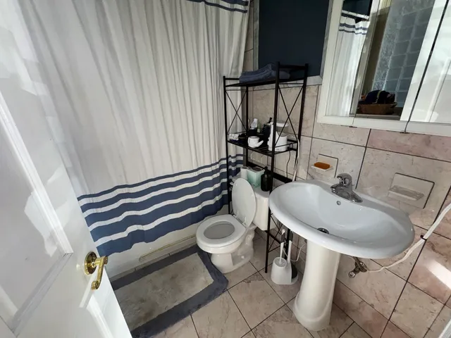 a bathroom with a sink toilet and shower