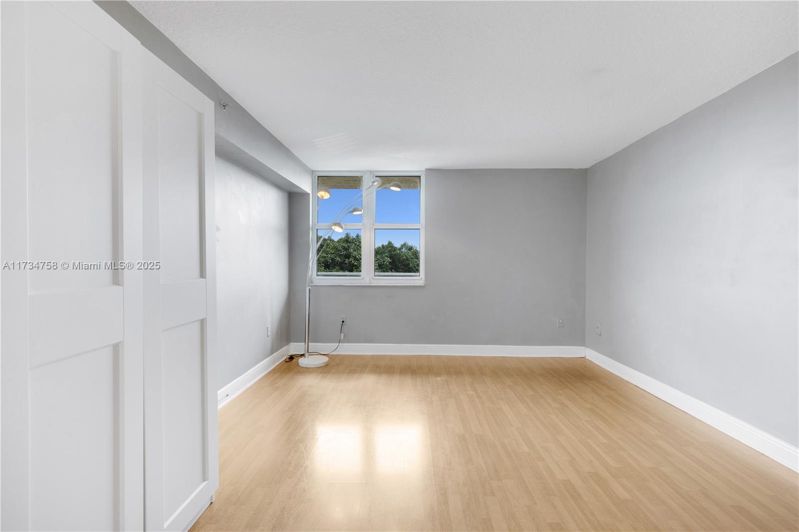 3000 Coral Way, Unit 513 Miami, FL 33145 - Photo 11 of 27 a view of a room with wooden floor and a window