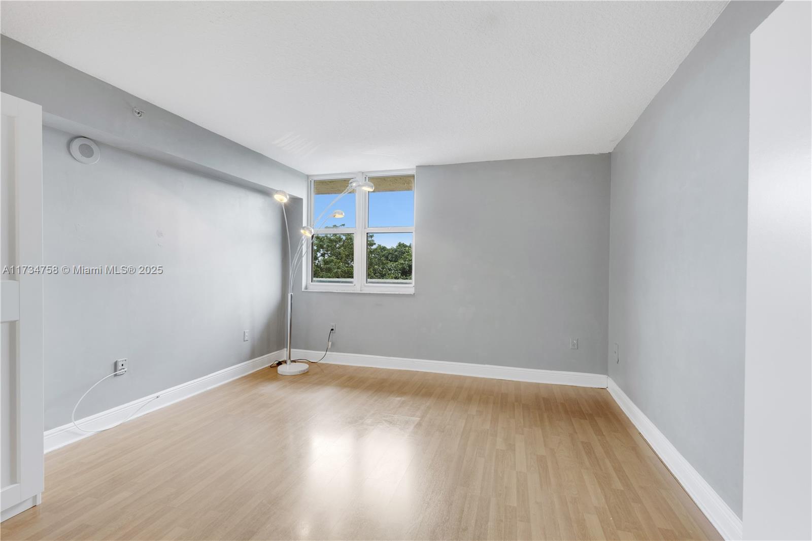3000 Coral Way, Unit 513 Miami, FL 33145 - Photo 12 of 27 an empty room with wooden floor and windows