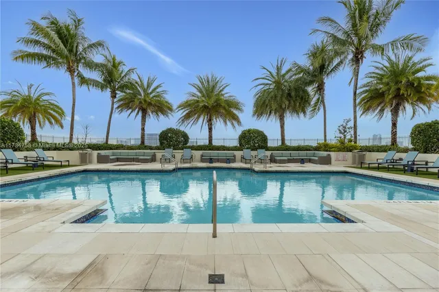 a view of a swimming pool with a table and chairs