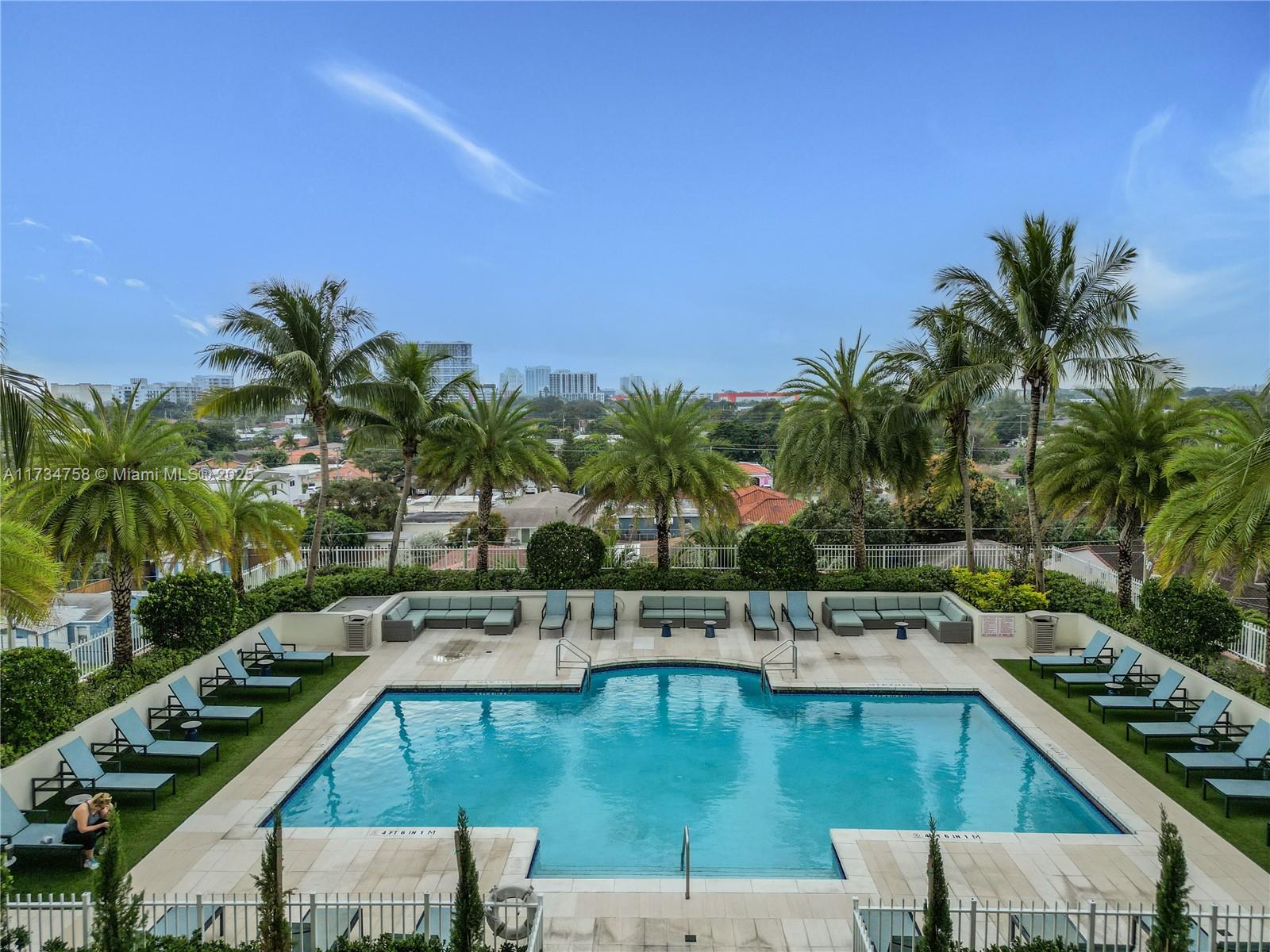 3000 Coral Way, Unit 513 Miami, FL 33145 - Photo 25 of 27 a view of a swimming pool with a lounge chair