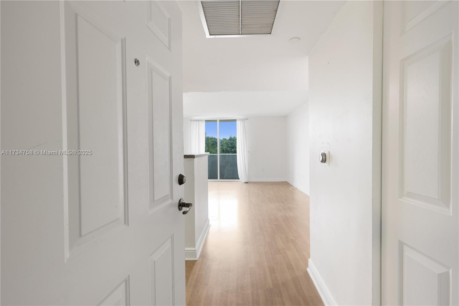 3000 Coral Way, Unit 513 Miami, FL 33145 - Photo 3 of 27 a view of a hallway with wooden floor