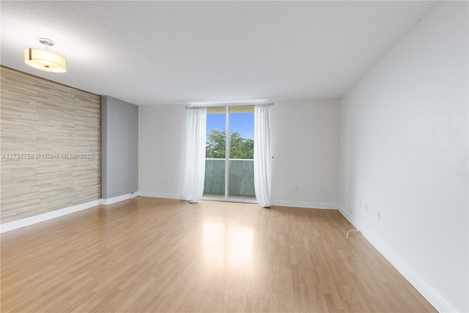 3000 Coral Way, Unit 513 Miami, FL 33145 - Photo 5 of 27 a view of an empty room with wooden floor and a window