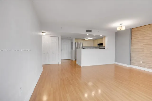 a view of a kitchen with a sink and a refrigerator