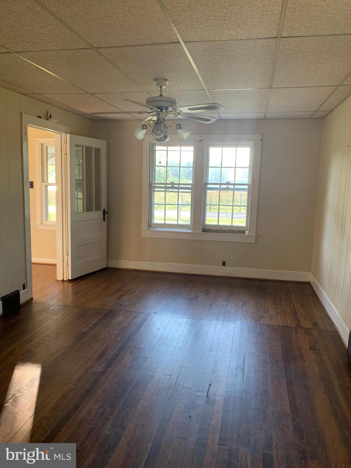 248 Readus Road Edinburg, VA 22824 - Photo 16 of 23 an empty room with wooden floor and windows