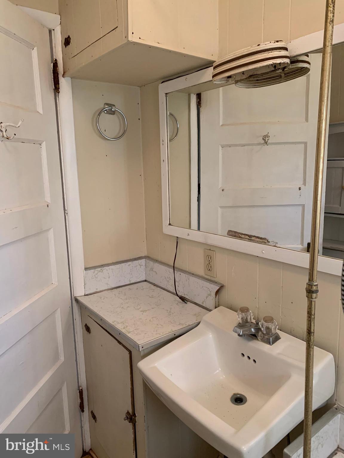 248 Readus Road Edinburg, VA 22824 - Photo 23 of 23 a bathroom with a sink and a mirror