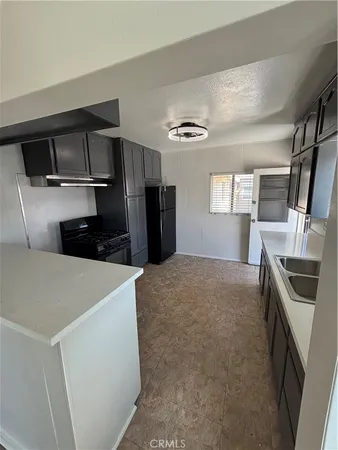 a kitchen with a refrigerator and a sink