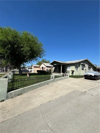 a view of a street with a car parked in front of it