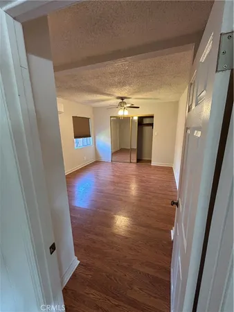 a view of a room with wooden floor and staircase