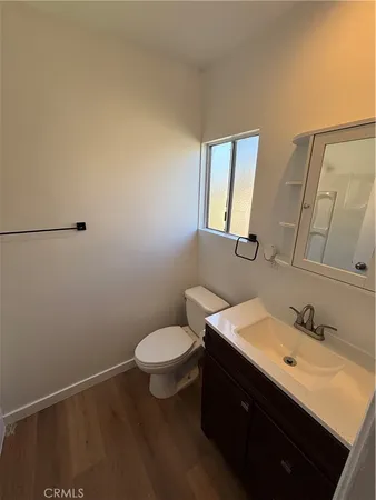 a bathroom with a sink mirror vanity and toilet
