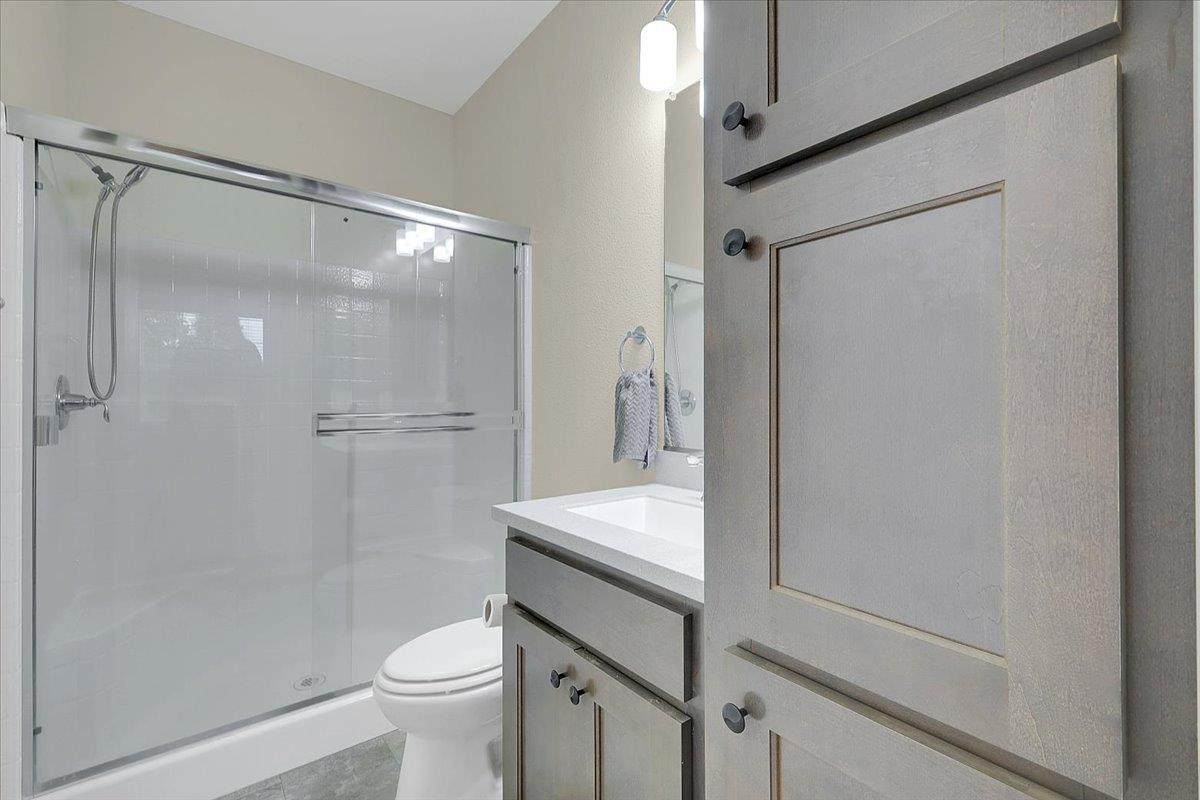 4667 Fruitland Road Marysville, CA 95901 - Photo 15 of 42 a bathroom with a granite countertop sink mirror toilet and shower