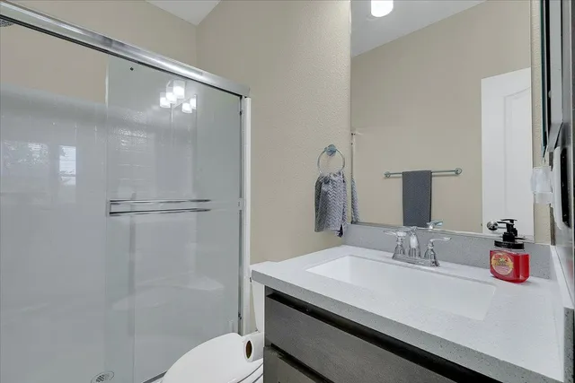 a bathroom with a sink toilet and shower