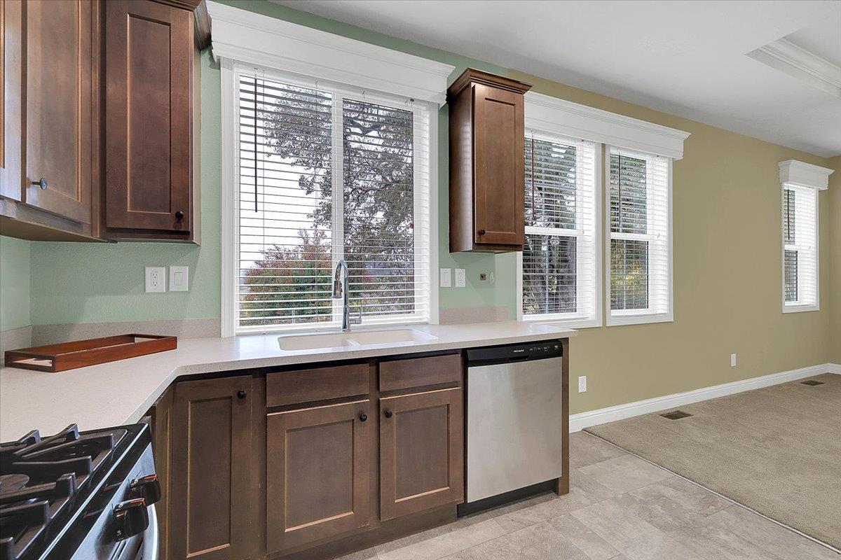 4667 Fruitland Road Marysville, CA 95901 - Photo 8 of 42 a kitchen with wooden cabinets and a window