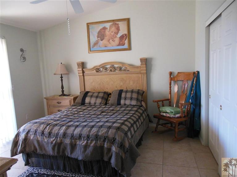 66033 Santa Rosa Road Desert Hot Springs, CA 92240 - Photo 11 of 21 a bedroom with a bed and painting on the wall
