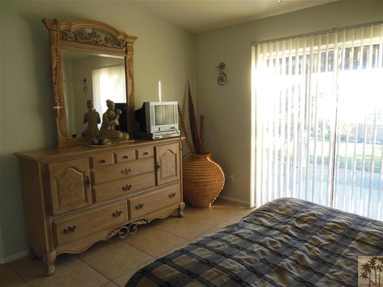 66033 Santa Rosa Road Desert Hot Springs, CA 92240 - Photo 12 of 21 a bedroom with a bed and a mirror on dresser