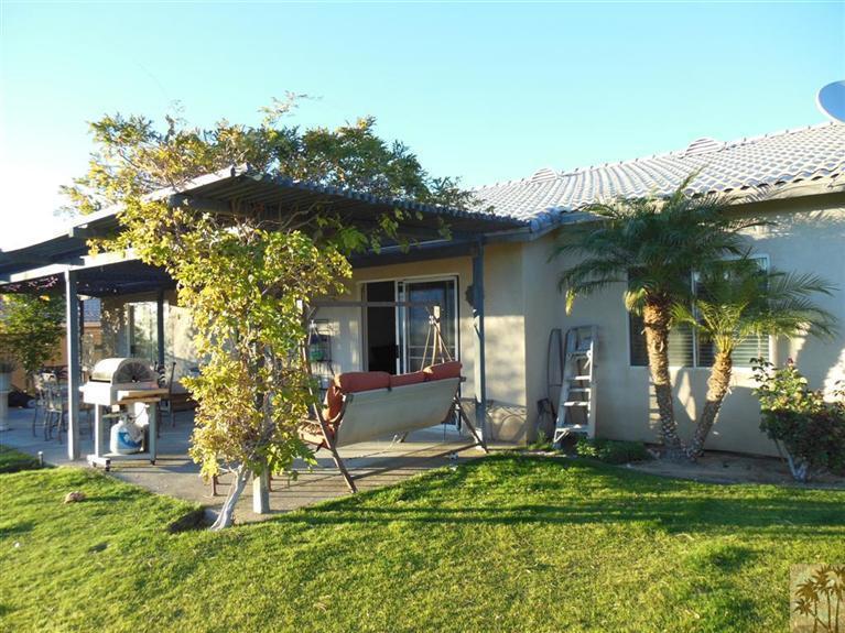 66033 Santa Rosa Road Desert Hot Springs, CA 92240 - Photo 17 of 21 a view of a house with a porch and furniture