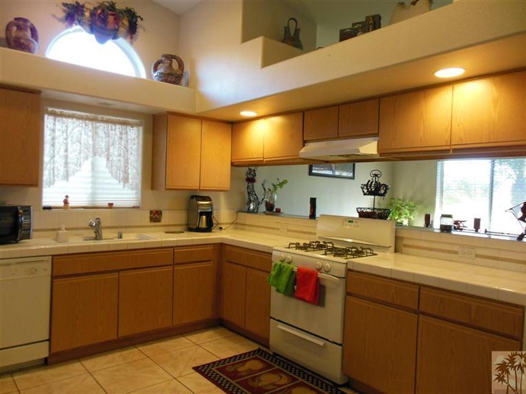 66033 Santa Rosa Road Desert Hot Springs, CA 92240 - Photo 6 of 21 a kitchen with a sink stove and cabinets