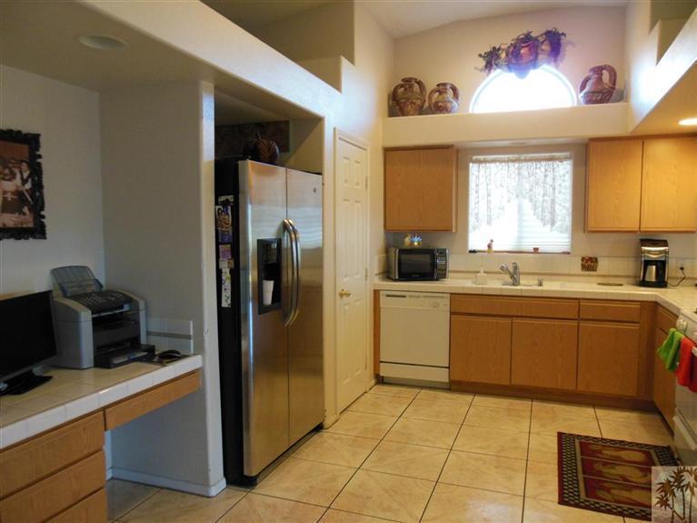 66033 Santa Rosa Road Desert Hot Springs, CA 92240 - Photo 7 of 21 a kitchen with a refrigerator and a sink