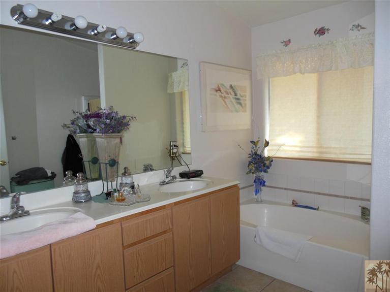 66033 Santa Rosa Road Desert Hot Springs, CA 92240 - Photo 10 of 21 a bathroom with a tub sink and mirror
