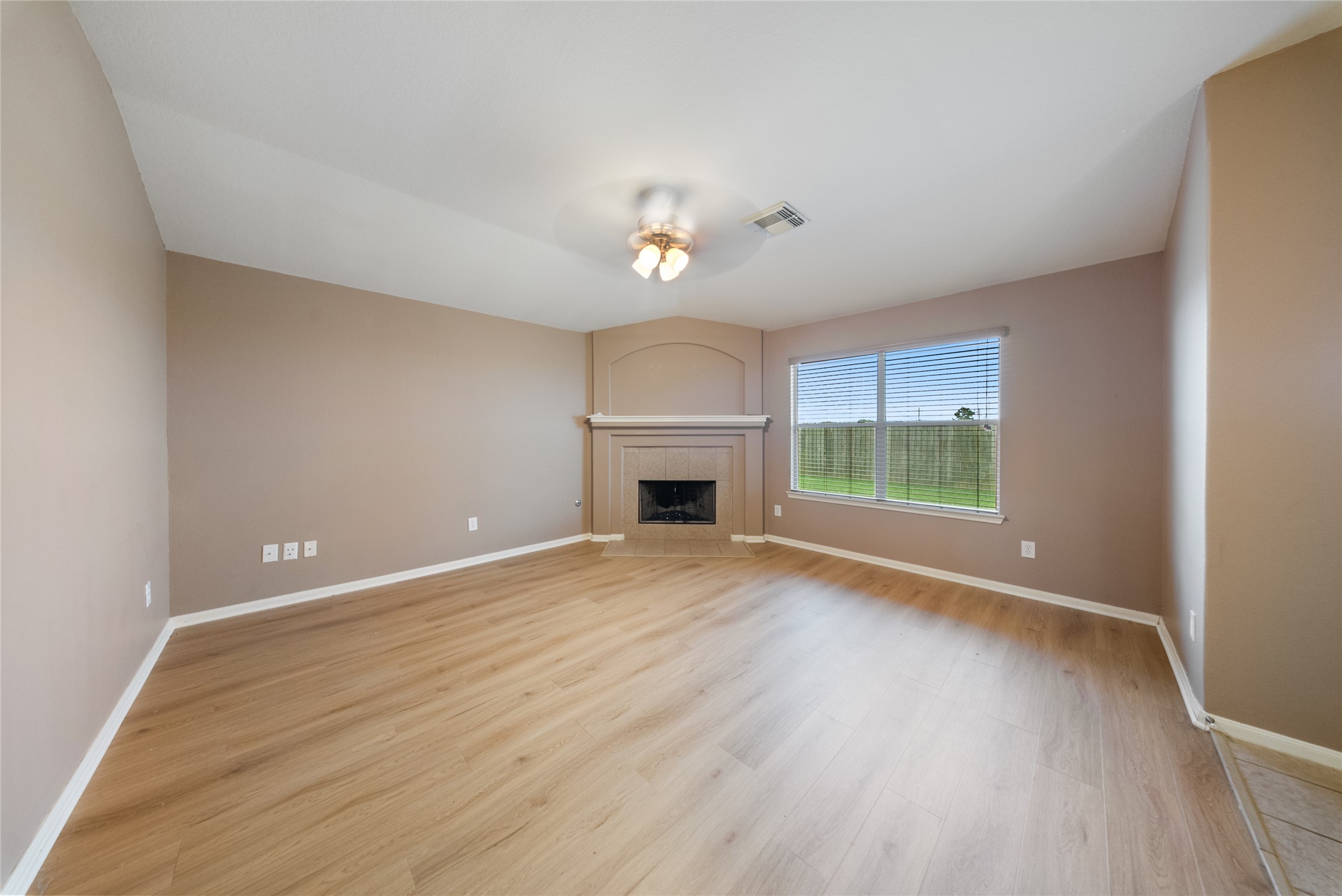 6007 Wilcox Point Drive Spring, TX 77388 - Photo 13 of 15 a view of empty room with wooden floor and fireplace
