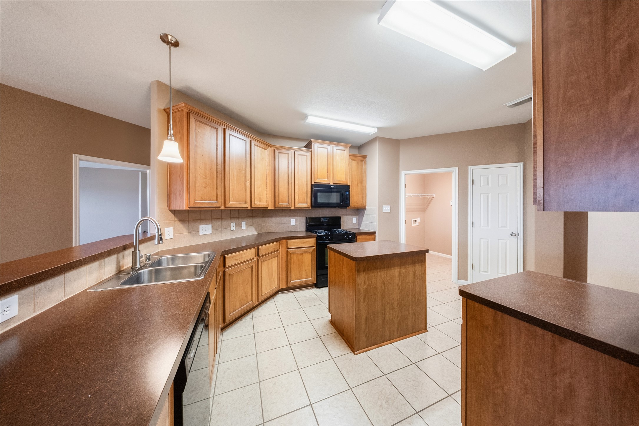 6007 Wilcox Point Drive Spring, TX 77388 - Photo 6 of 15 a living room with stainless steel appliances granite countertop a sink wooden cabinets and a granite counter top