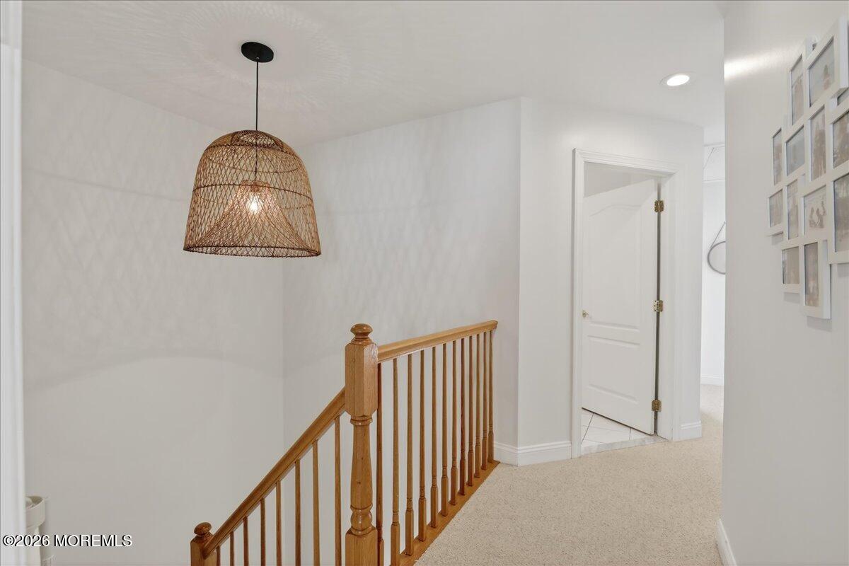 21 Riviera Drive Long Branch, NJ 07740 - Photo 17 of 64 a view of a hallway to a big room with a chandelier