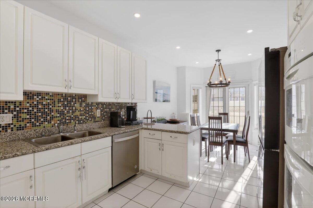 21 Riviera Drive Long Branch, NJ 07740 - Photo 18 of 64 a kitchen with granite countertop a sink stainless steel appliances and cabinets