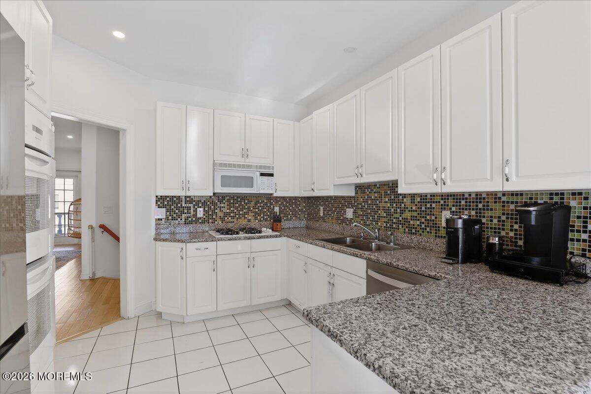 21 Riviera Drive Long Branch, NJ 07740 - Photo 19 of 64 a kitchen with a sink and cabinets