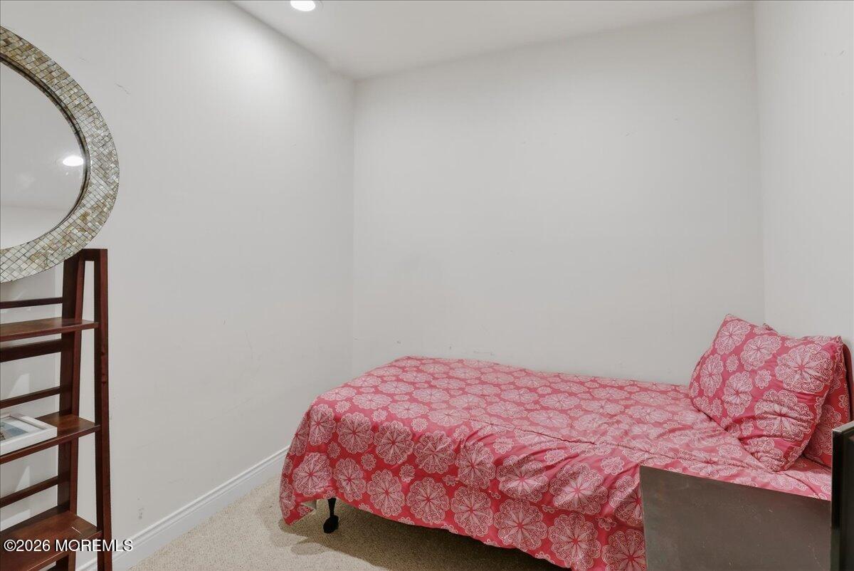 21 Riviera Drive Long Branch, NJ 07740 - Photo 29 of 64 a bedroom with a bed and a mirror