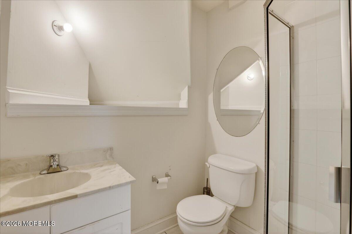 21 Riviera Drive Long Branch, NJ 07740 - Photo 30 of 64 a bathroom with a sink a toilet and a mirror