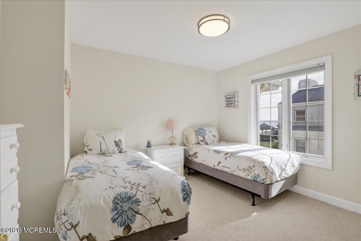 21 Riviera Drive Long Branch, NJ 07740 - Photo 31 of 64 a bedroom with two beds and a large window