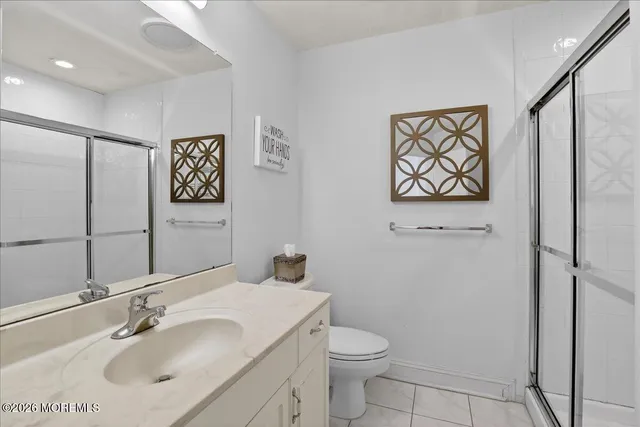 a bedroom with a bed and a mirror